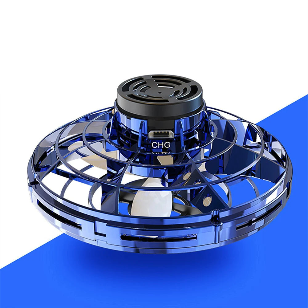 Mini hand-controlled flying spinner toy with black central motor housing and a USB-C port labeled 'CHG'. The product is shown floating against a split white and blue background.