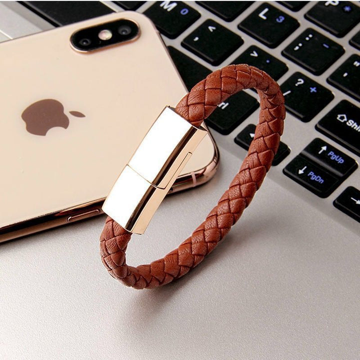 Brown braided Wearable smartphone charging cable bracelet  keyboard with an iPhone in the background