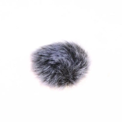 A gray faux fur microphone wind muffler on a solid white background.