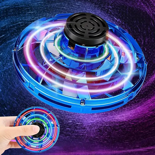 Mini hand-controlled flying spinner toy with a hand holding it against a dark background