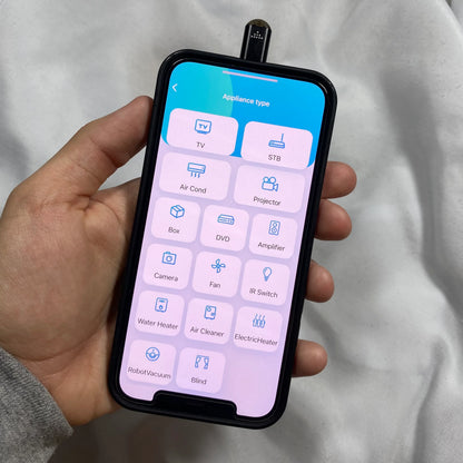 Hand holding a smartphone with an app interface Smartphone infrared remote control adapter