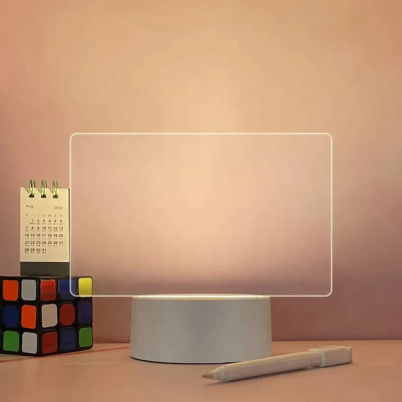 Rectangular light on a stand with a pen and calendar in the background LED acrylic message board with light-up writing