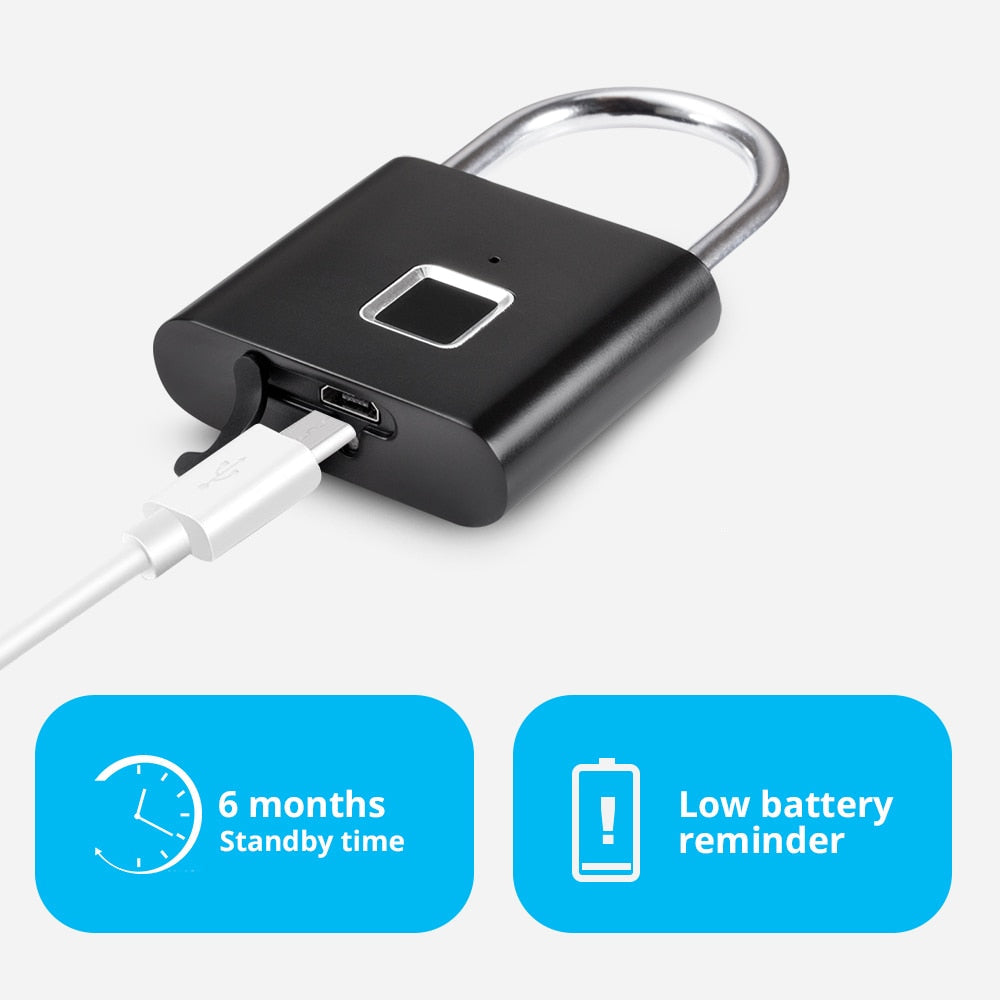 Smart fingerprint padlock with keyless unlocking with a silver metal loop and a white charging cable plugged into a USB-C port, shown on a light gray background with two blue feature callouts reading '6 months Standby time' and 'Low battery reminder'.